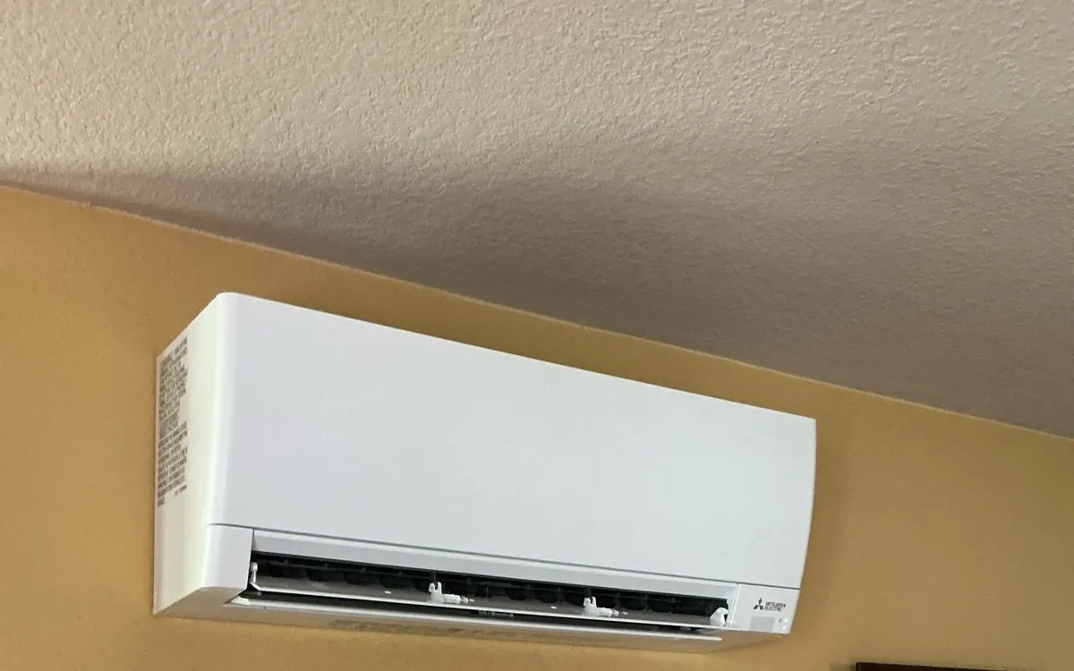 Ductless mini split head mounted on an interior wall
