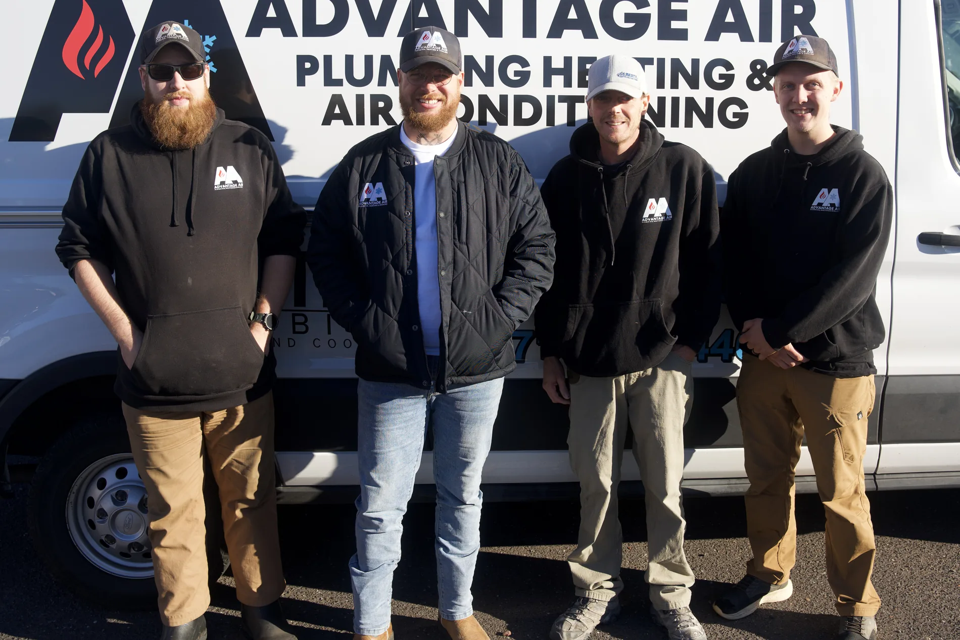 Advantage Air heating technicians beside a service van on Tower Avenue, Superior